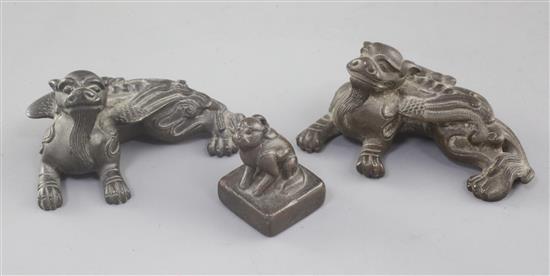 A pair of Chinese bronze mythical beast scroll weights and a similar seal, 18th/19th century, 6.5cm and 3cm